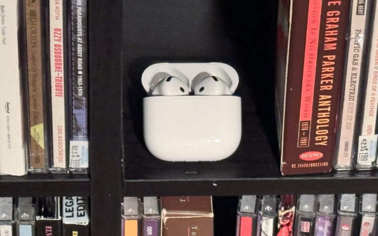 AirPods 4 with Active Noise Cancellation near CDs