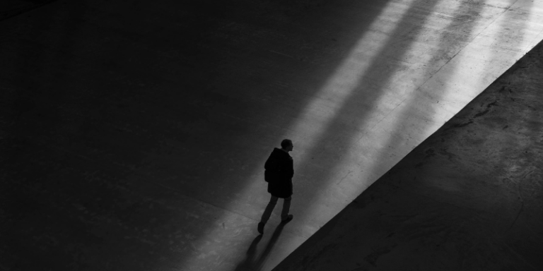 person walking in shadows