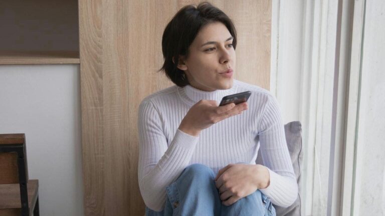 1 check out easy ways to make calls when vision is a challenge woman in white turtleneck speaking on phone