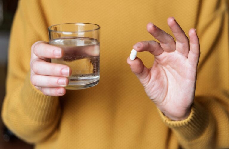 woman holding pill